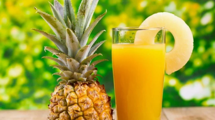Một người đang thưởng thức ly nước dứa
